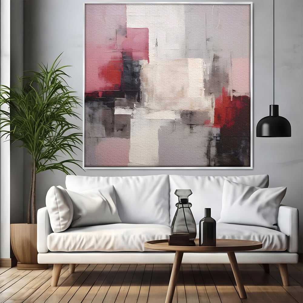 Tablou canvas cu pictura abstracta cu blocuri rosii si negre, in rama de aluminiu argintiu, pe perete intr-un living